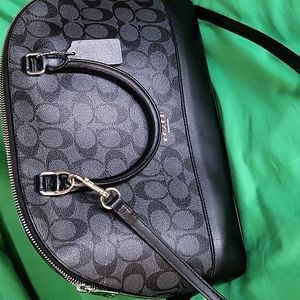 Coach Black and Grey Logo w/Strap.  Good condition, has small scratch on front.